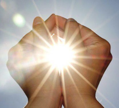 Symbolbild für Energiearbeit – Hände bündeln Licht in der Sonne
